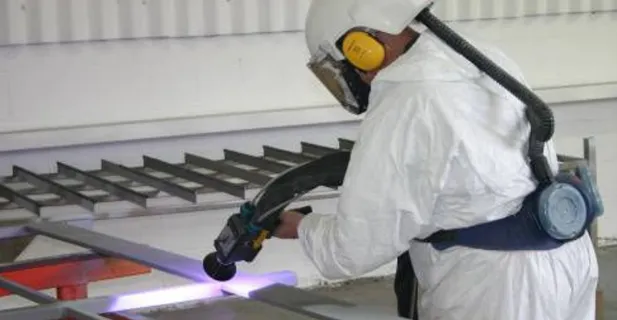 Zinc spraying a steel grating