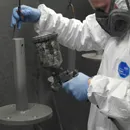 Spray coating a steel post in the spray booth